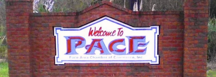 Welcome to Pace sign on a brick monument for the Pace Area Chamber of Commerce.