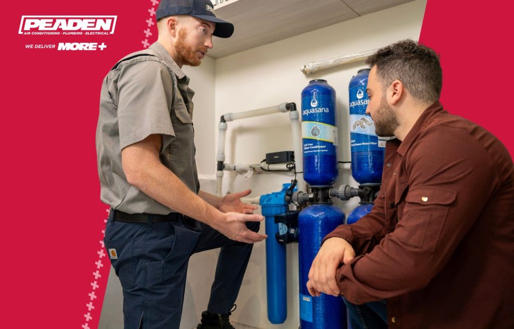 Plumber talking to a homeowner about The wrongly installed water softener