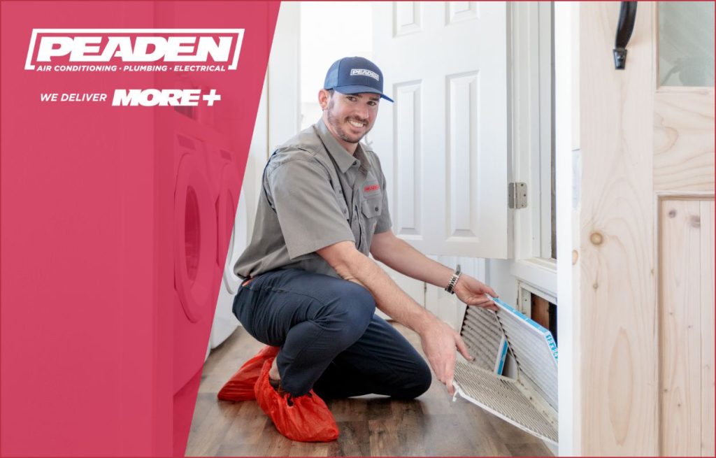 A Peaden HVAC tech replacing an air filter.