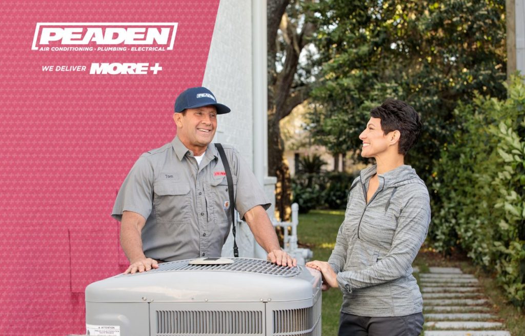 An HVAC technician explaining AC issues with homeowner.