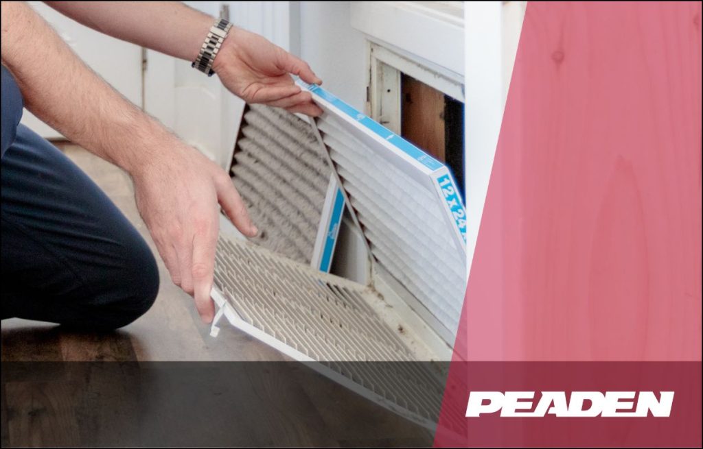 A Peaden in HVAC technician changing an air filter