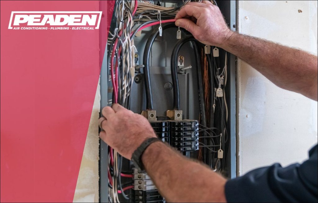 An electrician inspecting a electrical box