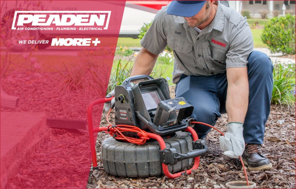 A Peaden plumber using a camera to see how water jetting might be useful.
