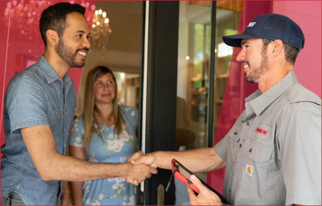 An HVAC technician shaking hands with the homeowner