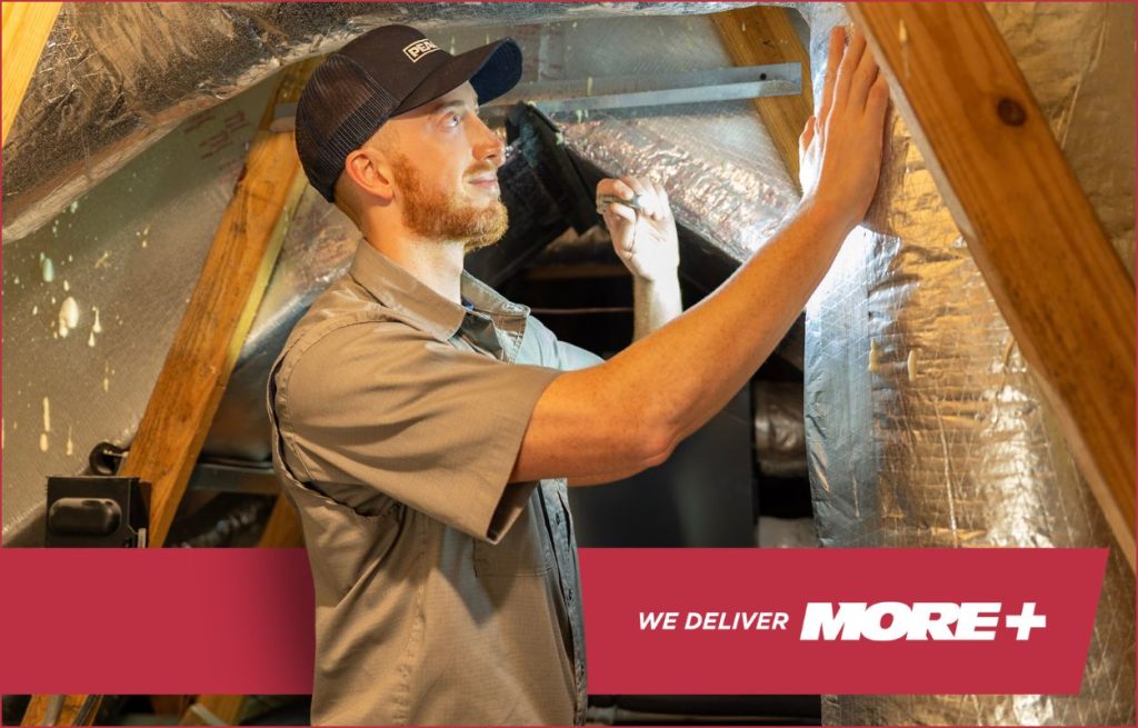 HVAC tech checking duct work.