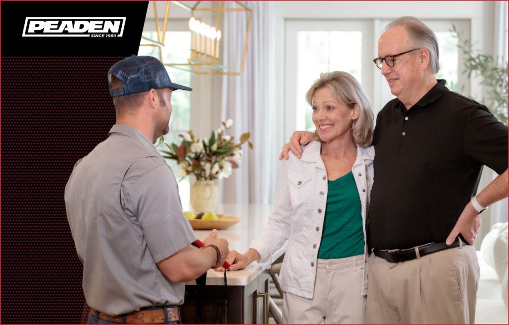 An electrician discusses a new electrical panel with the homeowners.