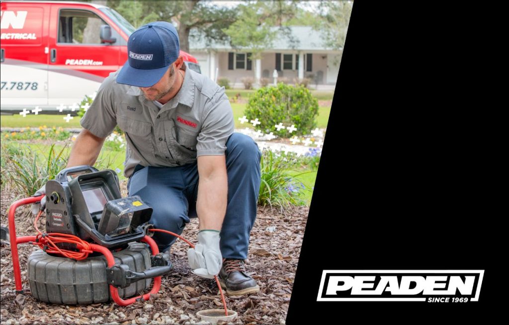 HVAC technician performing a pipe inspection with a sewer camera.