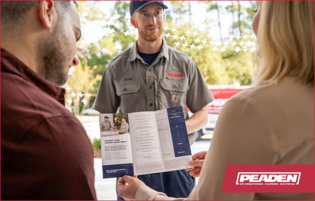 HVAC technician discussing HVAC maintenance with a couple