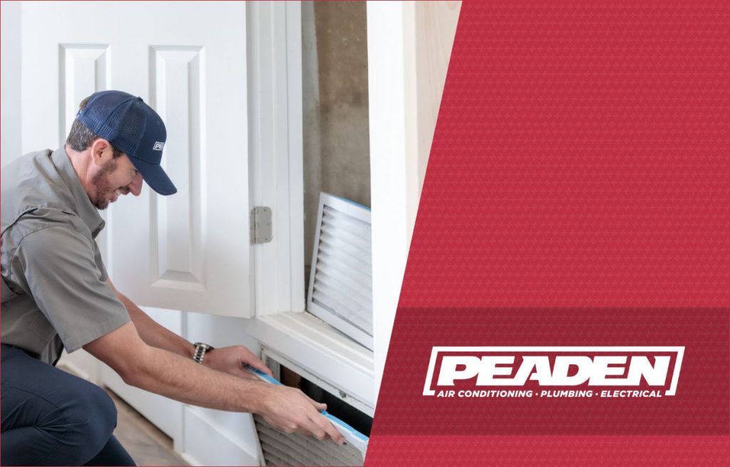A Peaden HVAC tech changing an air filter