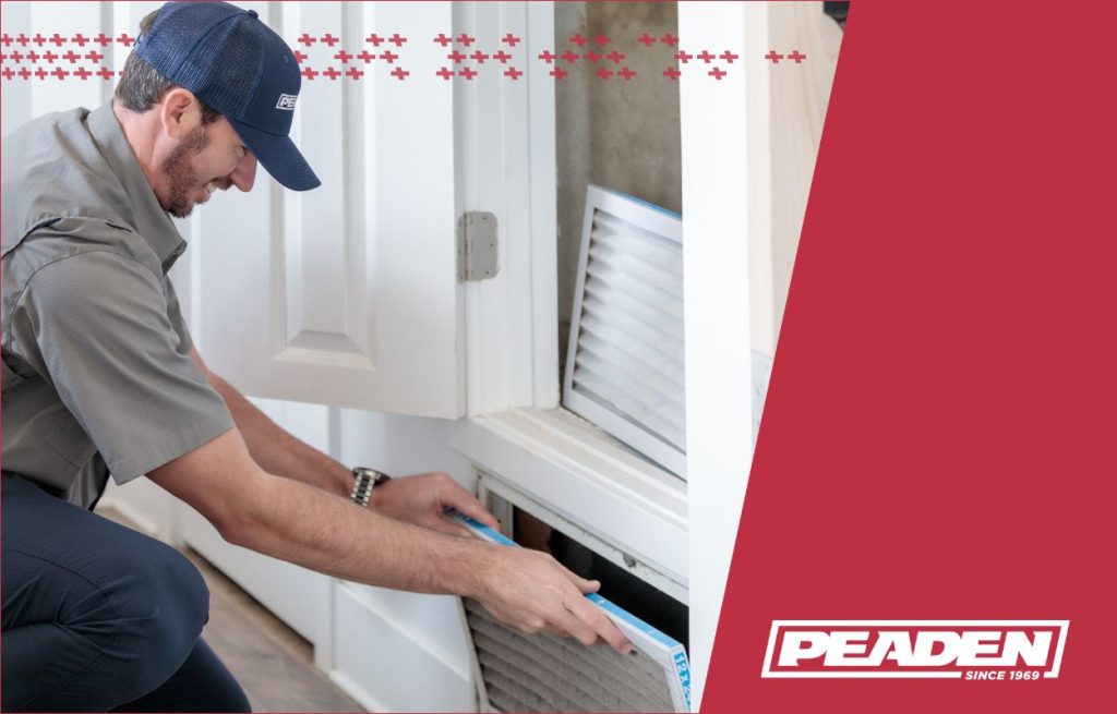 A Peaden HVAC tech changing an air filter