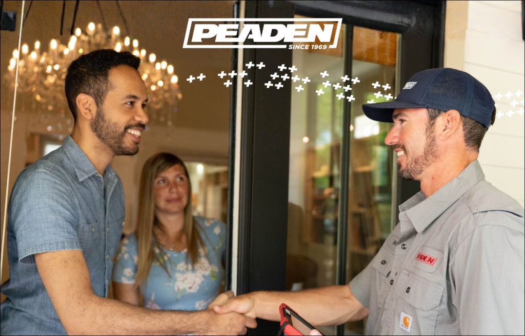 A HVAC technician shaking hands with a homeowner