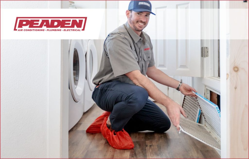 A Peaden HVAC tech changing an air filter