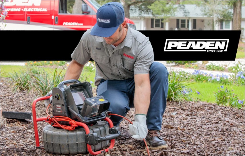 A Peaden plumber using a drain camera.