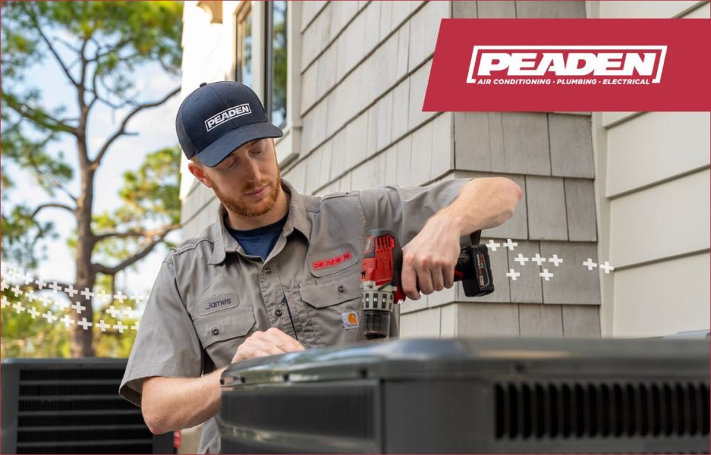 A Peaden HVAC tech installing a new AC unit.