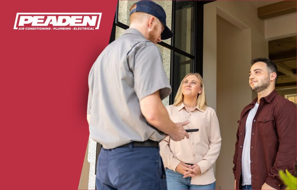 A Peaden HVAC tech discussing AC cost factors with homeowners.