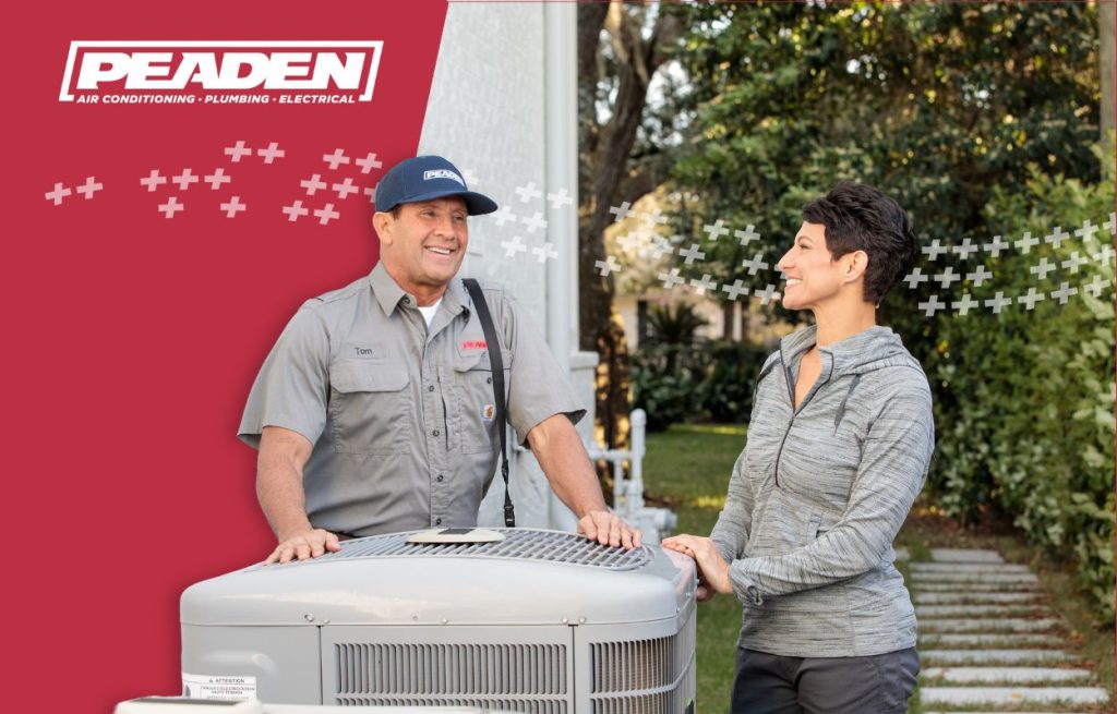 A Peaden HVAC tech discussing a heat pump.