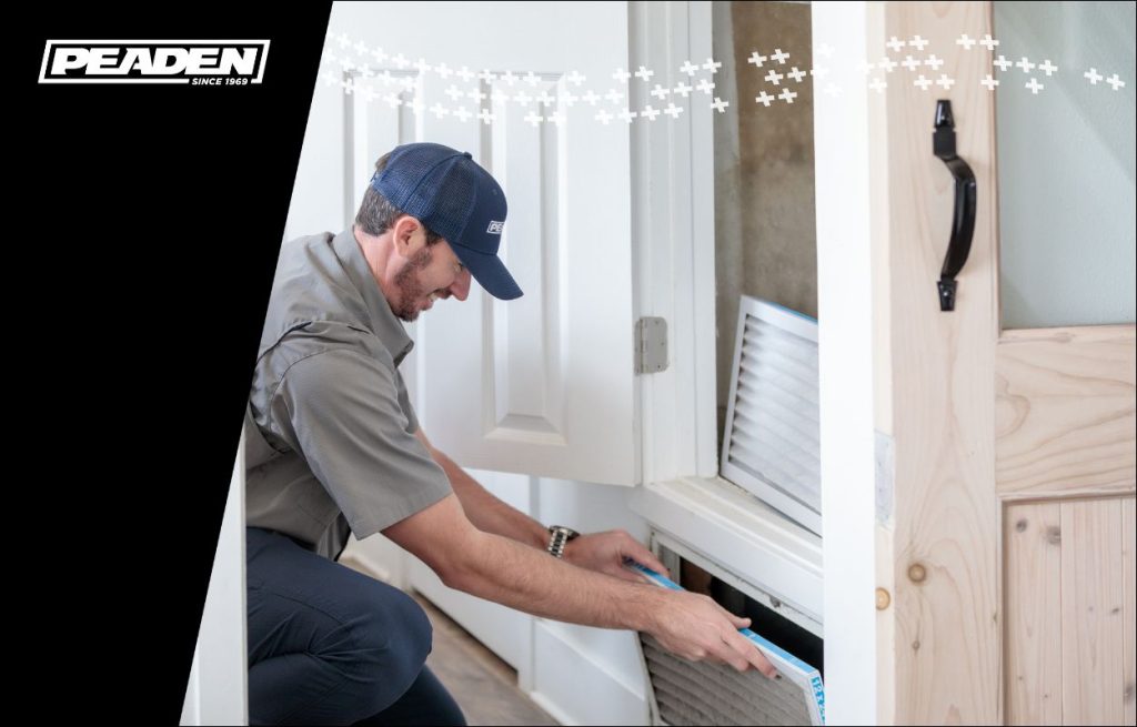 A Peaden HVAC tech changing an air filter