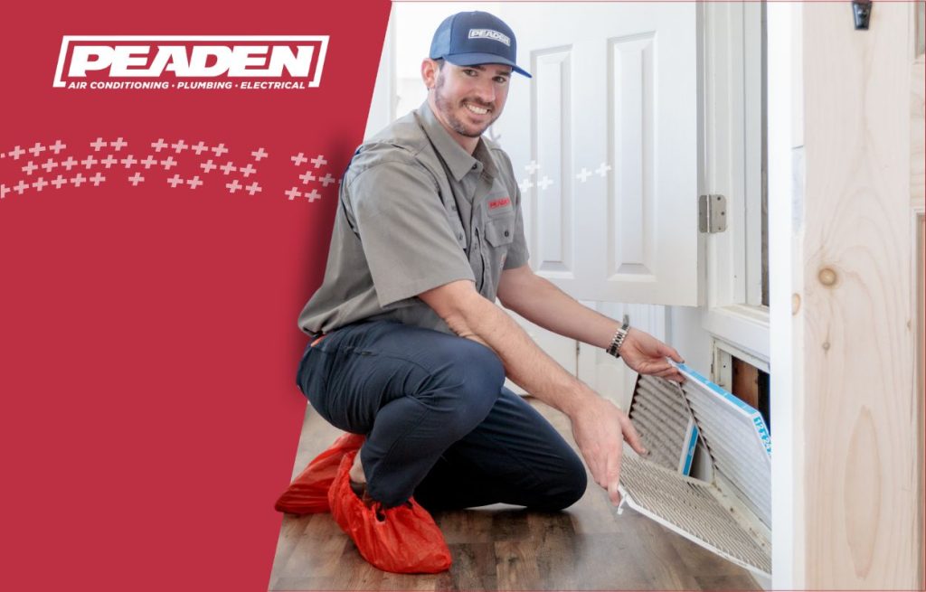 A Peaden HVAC tech changing an air filter