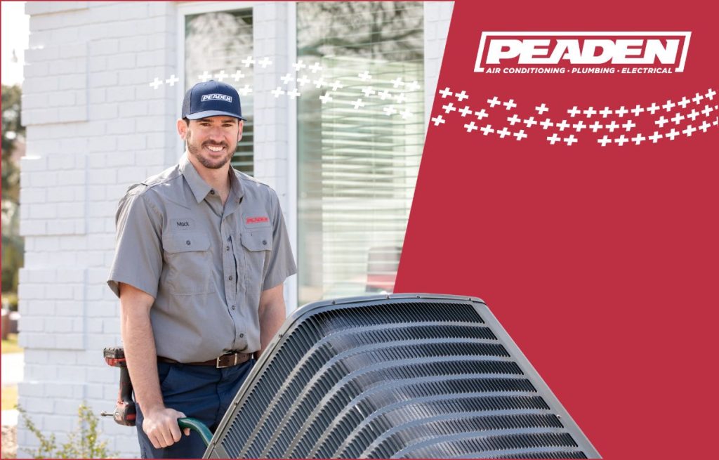 A Peaden HVAC tech working on a heat pump.