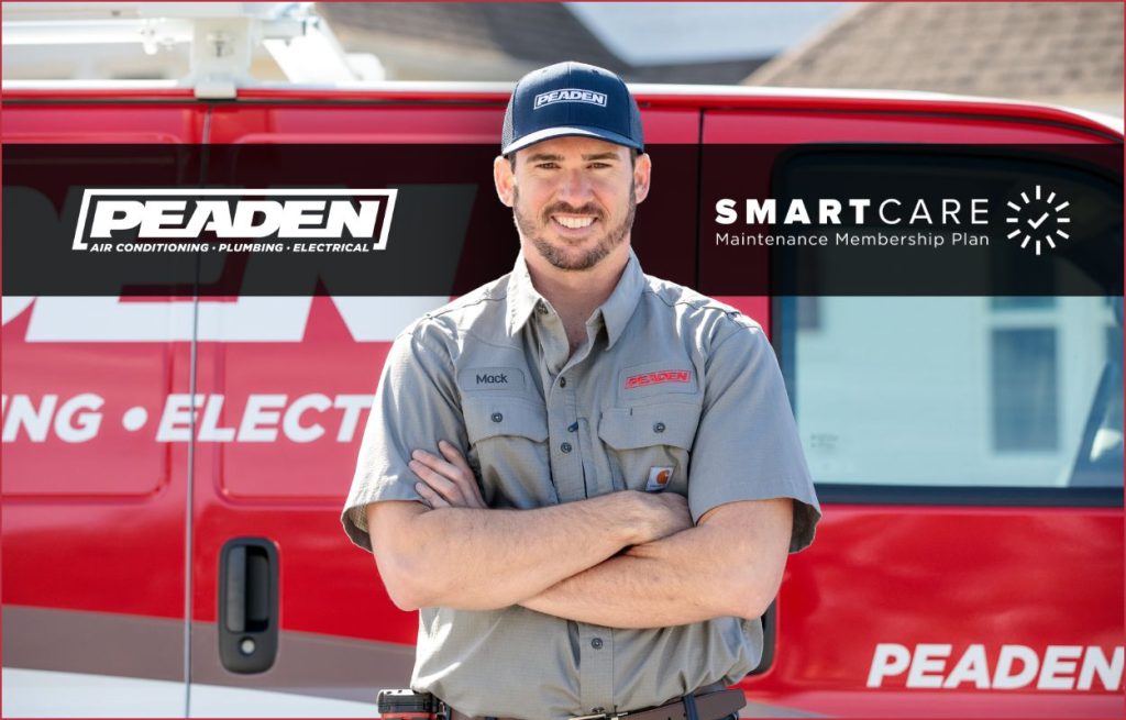 A Peaden HVAC tech in front of his van.