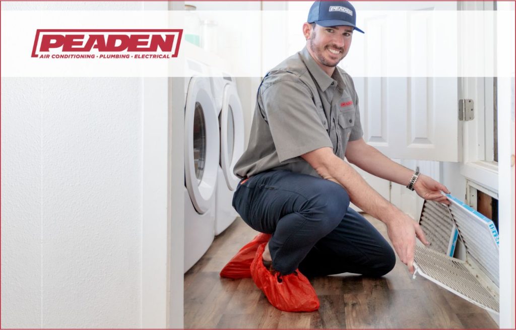 A Peaden HVAC tech changing an air filter