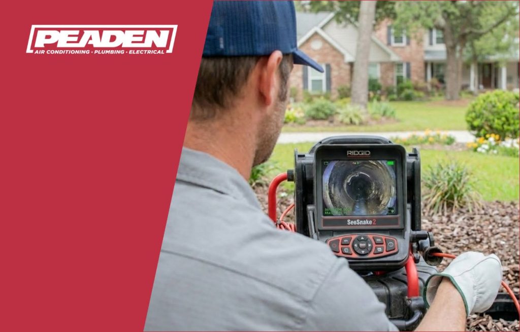 A Peaden plumber using a drain camera.