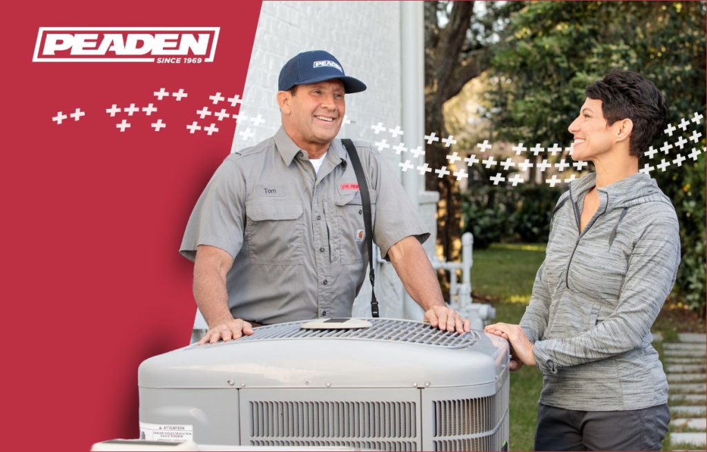 A Peaden HVAC tech discussing a heat pump.