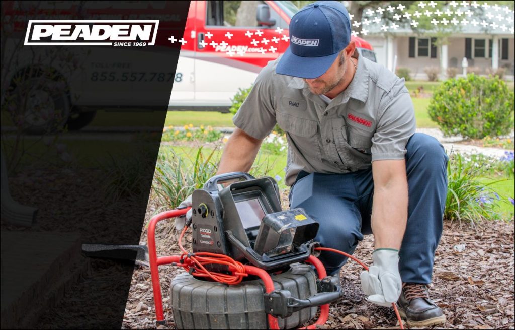 A Peaden plumber using a drain camera.