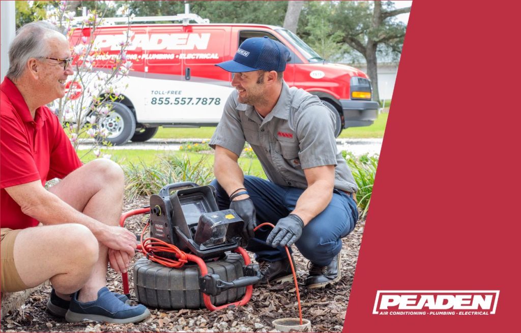 A Peaden plumber using a drain camera.