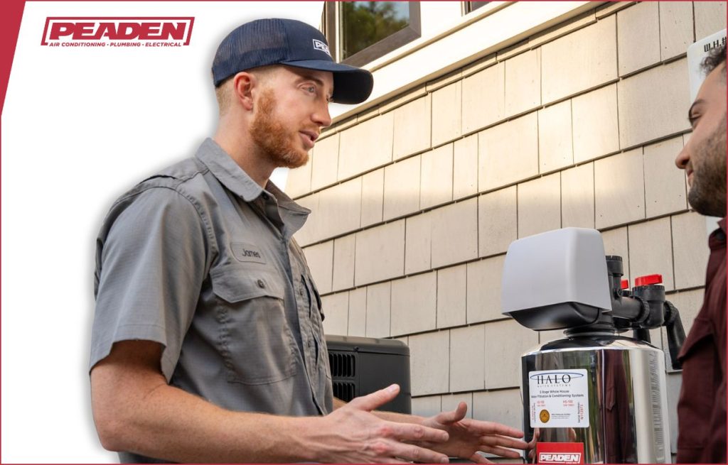 A Peaden plumber explaining water filtration to a client.