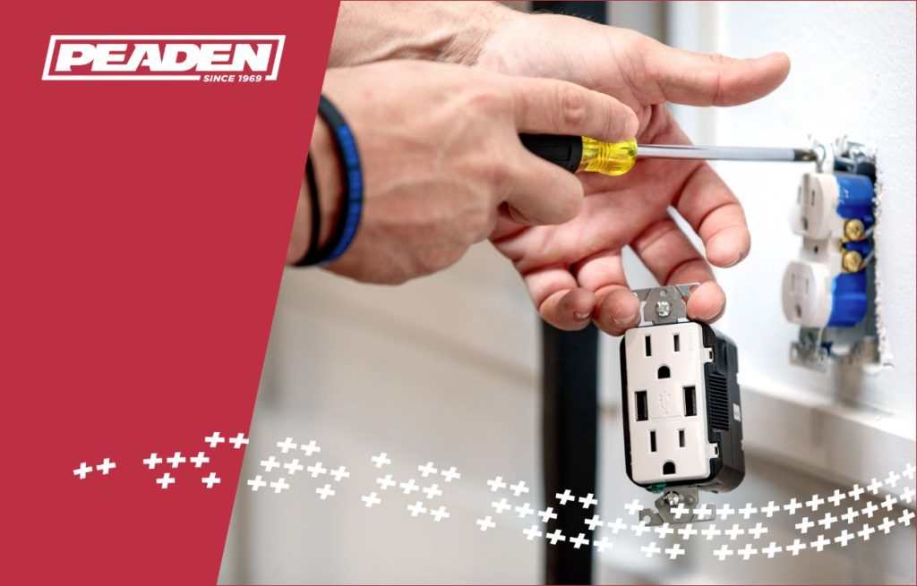A Peaden Electrician working on a outlet.