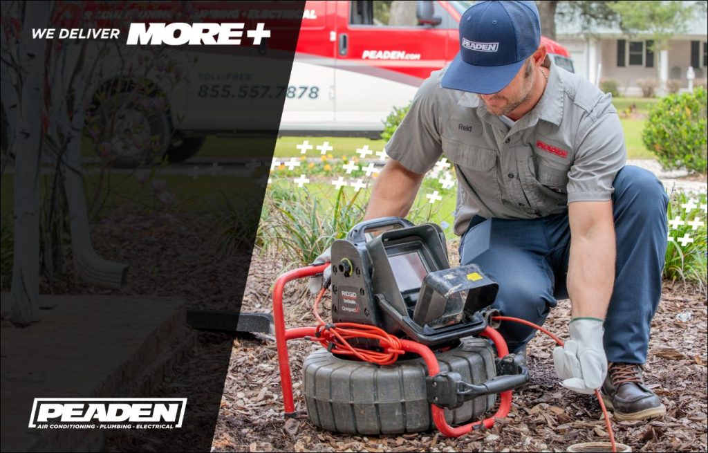 A Peaden plumber using a drain camera.