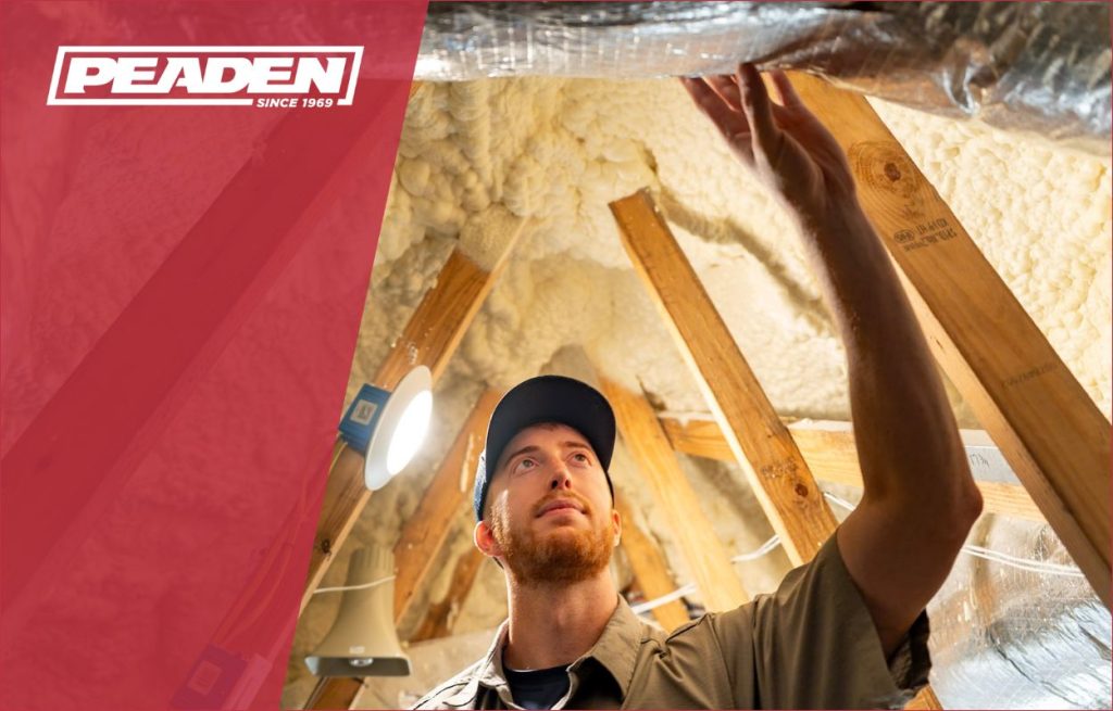 A Peaden HVAC tech working on a duct.