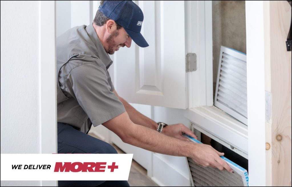 A Peaden HVAC tech changing an air filter