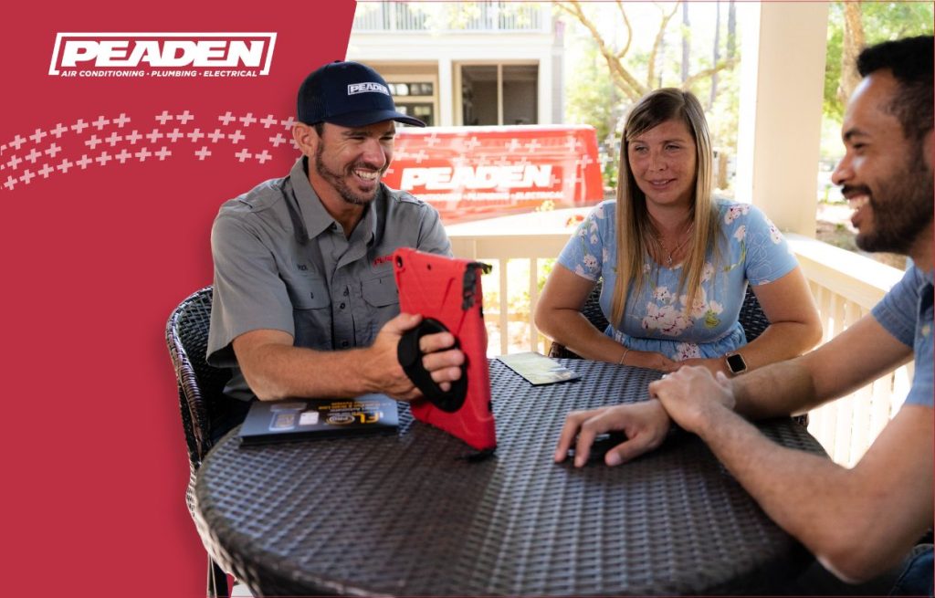 A Peaden plumber explaining water heaters to a client.