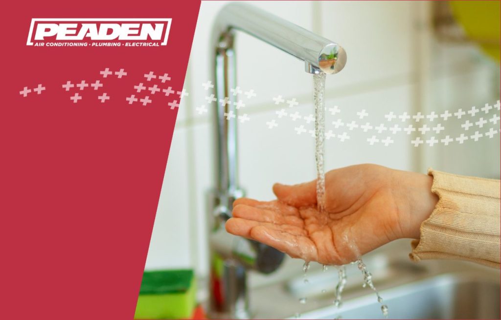 Testing the water temperature of the faucet