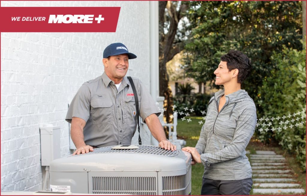 A Peaden HVAC tech discussing a new AC unit.