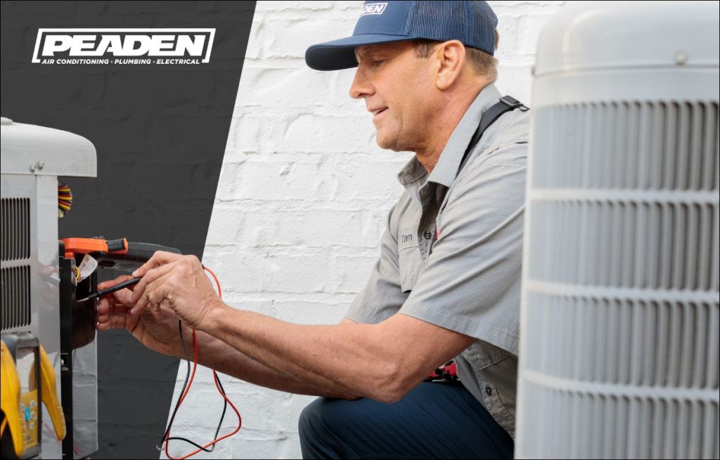 A Peaden HVAC tech working on a AC unit