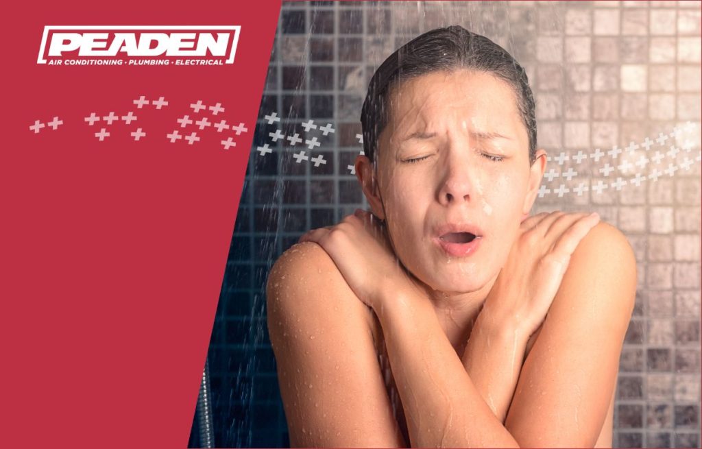 A women freezing in a cold shower.