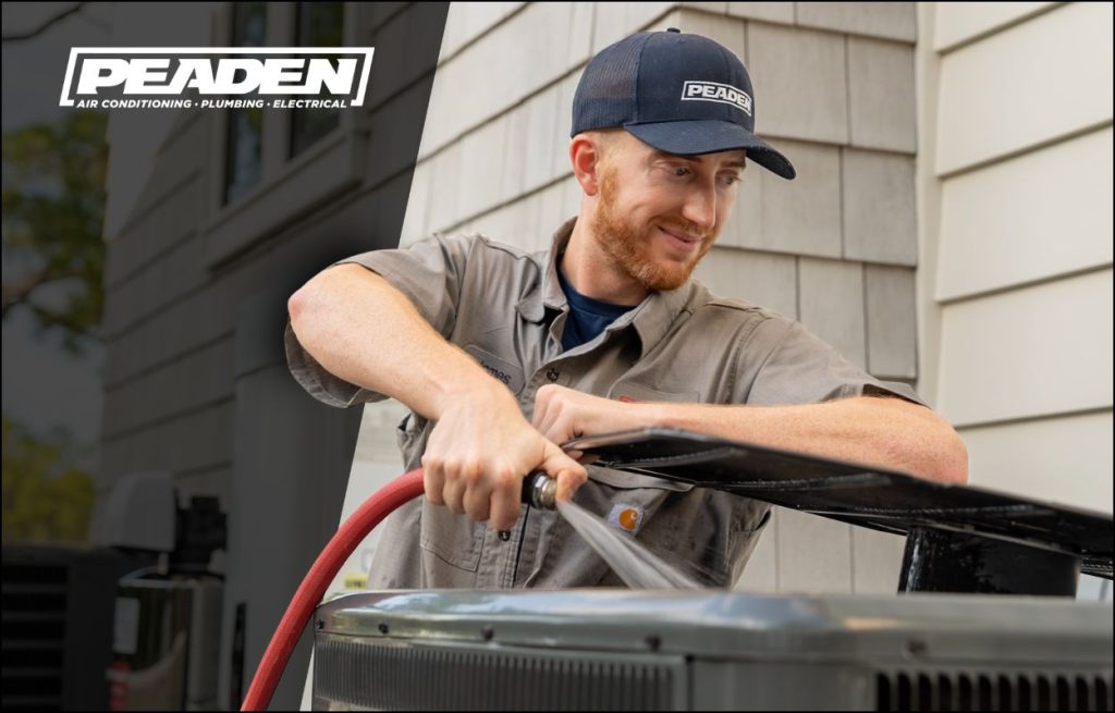 HVAC technician performing spring cleaning on a AC unit.