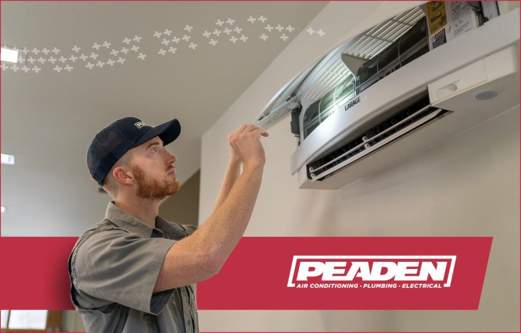 A Peaden HVAC tech working on a Mini Split AC Unit.