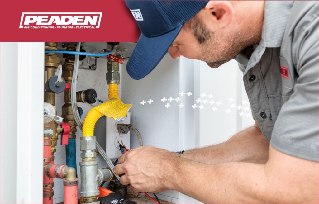 A Peaden plumber installing a tankless water heater.
