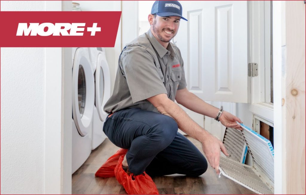 A Peaden HVAC tech changing an air filter