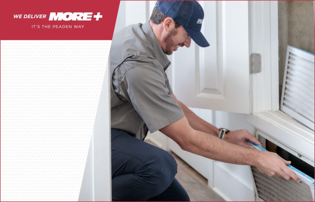 A Peaden HVAC tech changing an air filter