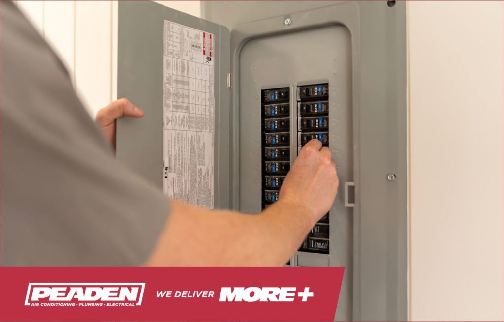 A Peaden Electrician working on a fuse box