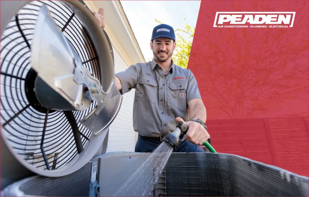 A Peaden Electrician cleaning an ac unit.