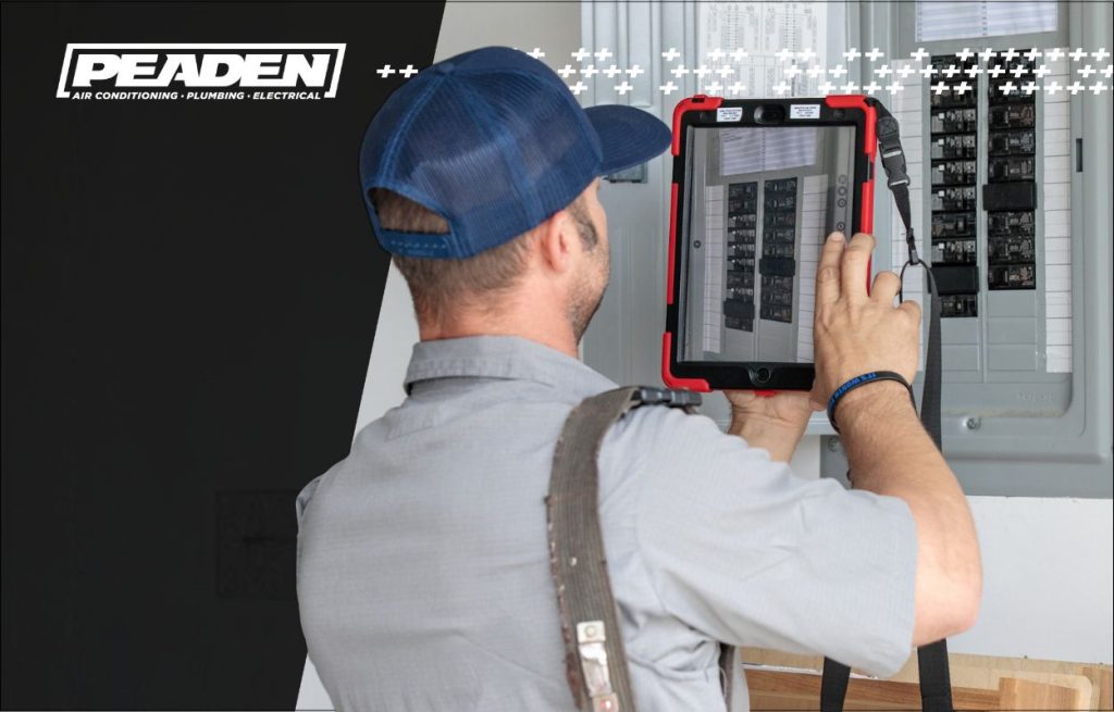 A Peaden Electrician working on a breaker box