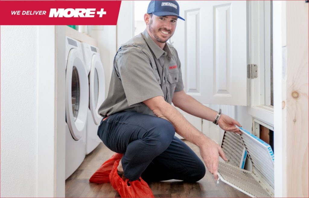A Peaden HVAC tech changing an air filter