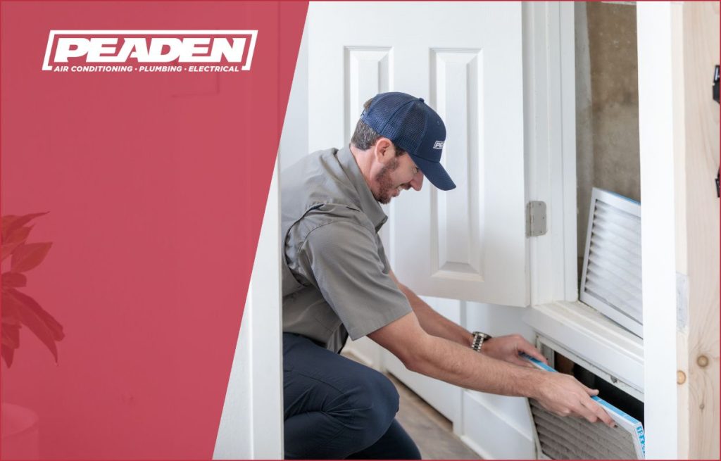 A Peaden HVAC tech changing an air filter