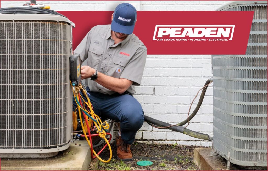 A Peaden HVAC tech working on a heat pump.